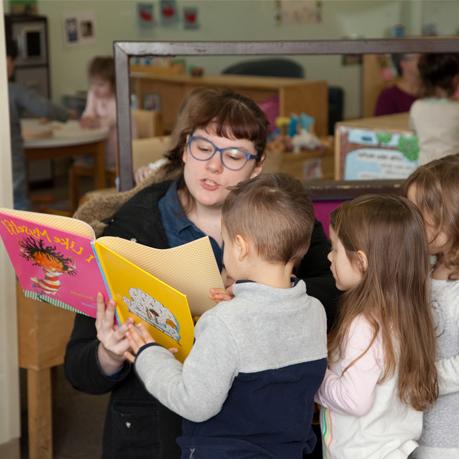 Woman reading book to child